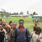17- Zozo High School buildings, primary school students carrying new desks