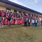2 tulla students in front of new classroom block