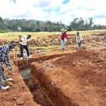 4 workers checking measurements