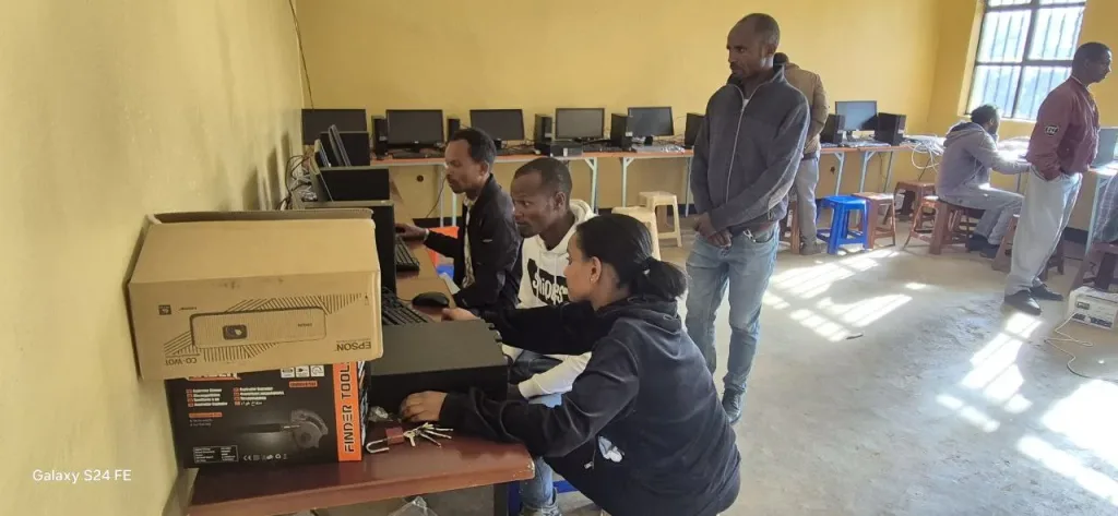 Rapport d’Activités Juillet-Dec 2025 9 computer technician helping shama laka ps teachers